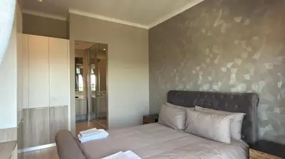 a bedroom with a bed and a large mirror at Deluxe fully furnished apartment in Menlyn Maine residence 902 in Pretoria