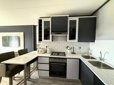 a kitchen with a sink and a stove top oven at Legacy Suites Montana in Pretoria
