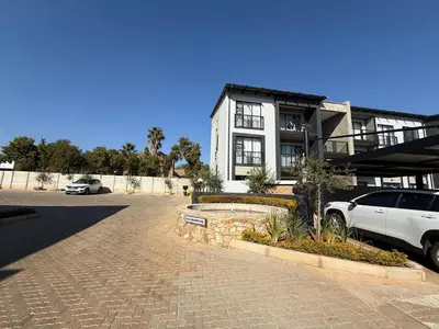 a white car parked in front of a house at Legacy Suites Montana in Pretoria