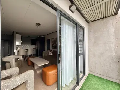 a living room with a large sliding glass door at Legacy Suites Montana in Pretoria