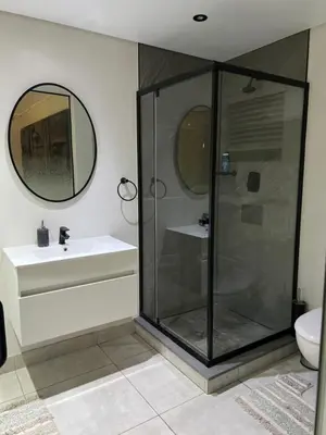 a bathroom with a shower and a sink and a toilet at 5 Bronco The Polofields in Midrand