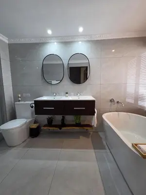 a bathroom with a sink and a tub and a toilet at 76 Zebula- Premium Luxurious Villa in Bela-Bela! in Warmbaths