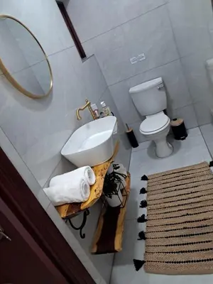 a bathroom with a sink and a toilet and a mirror at 76 Zebula- Premium Luxurious Villa in Bela-Bela! in Warmbaths