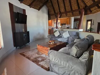 a living room with two couches and a tv at 76 Zebula- Premium Luxurious Villa in Bela-Bela! in Warmbaths