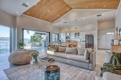 a living room with a couch and a table at Pecanwood Summit Shores Villa in Hartbeespoort
