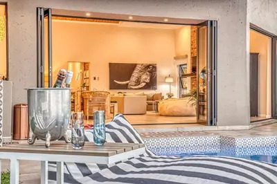 a room with a table and a living room at Pecanwood Summit Shores Villa in Hartbeespoort
