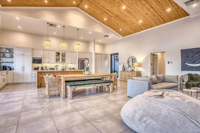a kitchen and living room with a table and a couch at Pecanwood Summit Shores Villa in Hartbeespoort