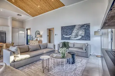 a living room with a couch and a table at Pecanwood Summit Shores Villa in Hartbeespoort