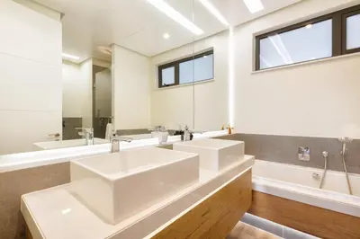 a bathroom with two sinks and a large mirror at #Alimama Spaces The Manson's Steyn City in Midrand
