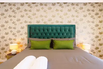a bedroom with a bed with a green headboard at #Alimama Spaces The Manson's Steyn City in Midrand