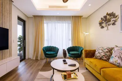 a living room with a yellow couch and green chairs at #Alimama Spaces The Manson's Steyn City in Midrand
