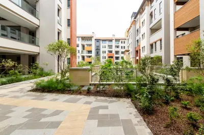 a courtyard in an apartment building with buildings at #Alimama Spaces The Manson's Steyn City in Midrand