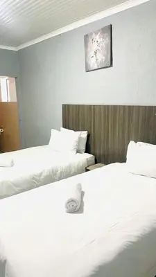 two beds sitting next to each other in a room at 373 Guest House in Pretoria