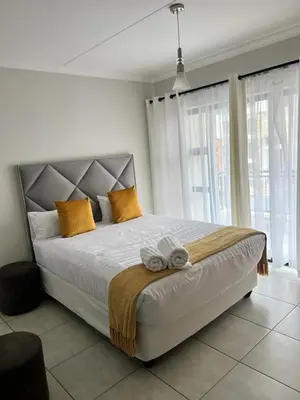 a bedroom with a large bed with yellow pillows at The lagoon retreat in Avondzon