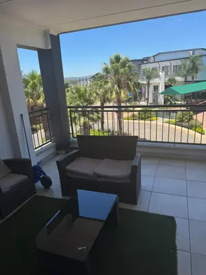 a living room with a couch and a large window at The lagoon retreat in Avondzon