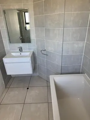 a bathroom with a sink and a mirror and a tub at The lagoon retreat in Avondzon