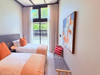a room with two beds and a window at 41 on 20th in Pretoria