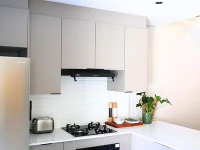 a kitchen with white cabinets and a stove at 41 on 20th in Pretoria