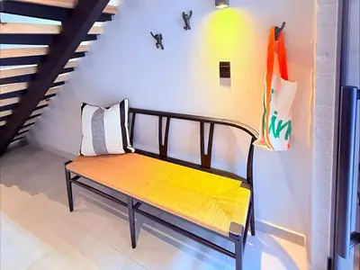 a bench sitting in a room next to a staircase at 41 on 20th in Pretoria