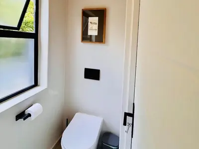 a small bathroom with a toilet and a window at 41 on 20th in Pretoria