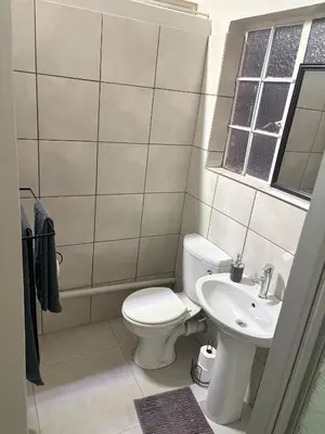 a bathroom with a toilet and a sink at Green Haven Waitara in Tzaneen