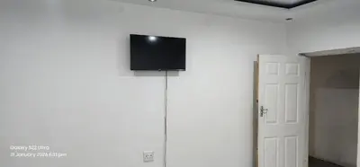 a flat screen tv on the wall of a room at Thohoyandou P house rooms in Thohoyandou