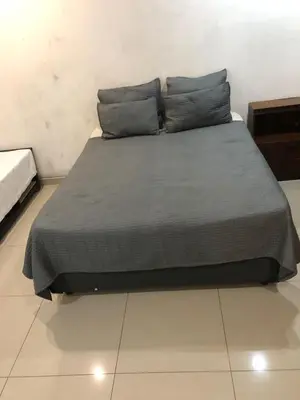 a bed with two pillows on it in a room at Thohoyandou P house rooms in Thohoyandou
