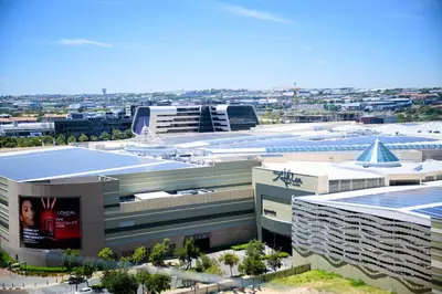 an overhead view of a building with a city in the background at SoftStay Ellipse Luxury Apartment in Midrand