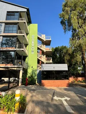 a building with a bus parked in front of it at 101 Brooklyn Stylish Apartment in Pretoria