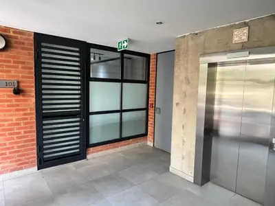an entrance to a building with a exit sign on it at 101 Brooklyn Stylish Apartment in Pretoria