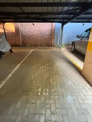 a parking garage with a car parked in it at 101 Brooklyn Stylish Apartment in Pretoria