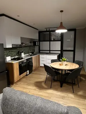 a kitchen with a table and chairs in a room at 101 Brooklyn Stylish Apartment in Pretoria