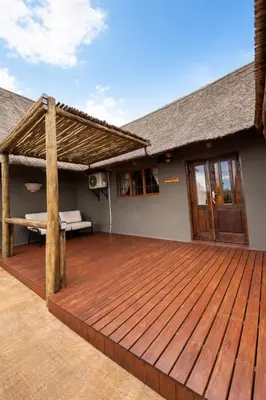 a wooden deck in front of a house at Mathendele Bush Lodge in Oporto