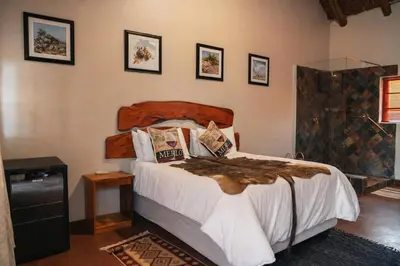 a bedroom with a large bed in a room at Mathendele Bush Lodge in Oporto