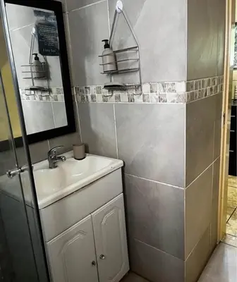 a small bathroom with a sink and a mirror at Bra Phuti' Place in Pretoria