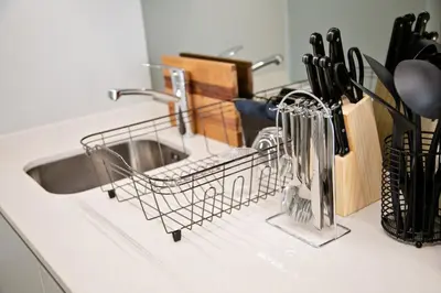 a dish drying rack next to a kitchen sink at Ad Astra Studio Apartment - Waterfall in Midrand