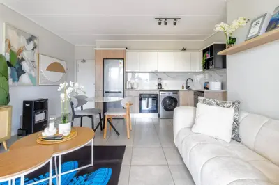 a living room with a couch and a table at AlimamaSpaces Mikes Munyaka in Midrand