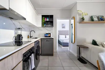 a kitchen with a sink and a dishwasher at AlimamaSpaces Mikes Munyaka in Midrand