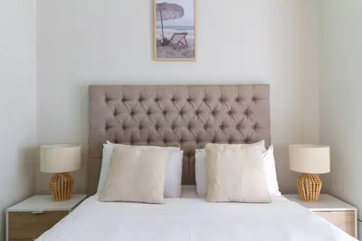 a bedroom with a large bed with two lamps at AlimamaSpaces Mikes Munyaka in Midrand