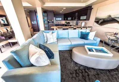a living room with two blue couches and a table at Ubuntu A home away from home in Midrand