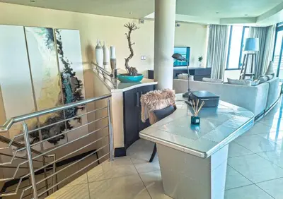 a living room with a table and a couch at Ubuntu A home away from home in Midrand