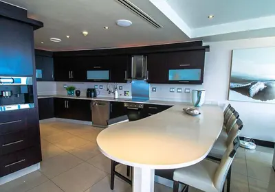 a kitchen with a wooden table and a table and chairs at Ubuntu A home away from home in Midrand
