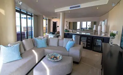 a living room with a couch and a table at Ubuntu A home away from home in Midrand