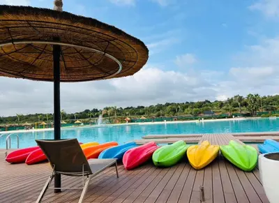 a row of colorful chairs sitting next to a pool at 1 Bedroom Apartment at The Blyde, Pretoria in Pretoria