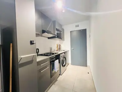 a small kitchen with a sink and a stove at Circa Urban Suite in Pretoria