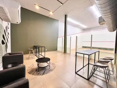 a room with chairs and tables and a tennis court at Circa Urban Suite in Pretoria