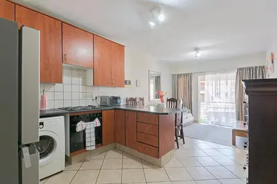 a kitchen with a washer and dryer at Calmwood Stay in Midrand