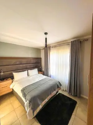 a bedroom with a large bed and a window at chillasclub&Bnb in Nelspruit