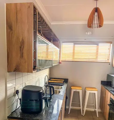 a kitchen with a stove and a pot on a counter at chillasclub&Bnb in Nelspruit