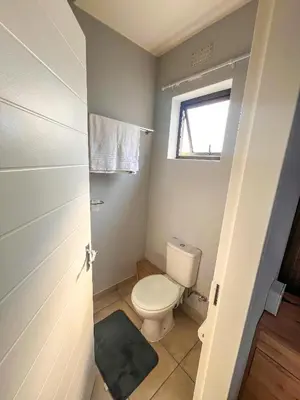 a small bathroom with a toilet and a window at chillasclub&Bnb in Nelspruit
